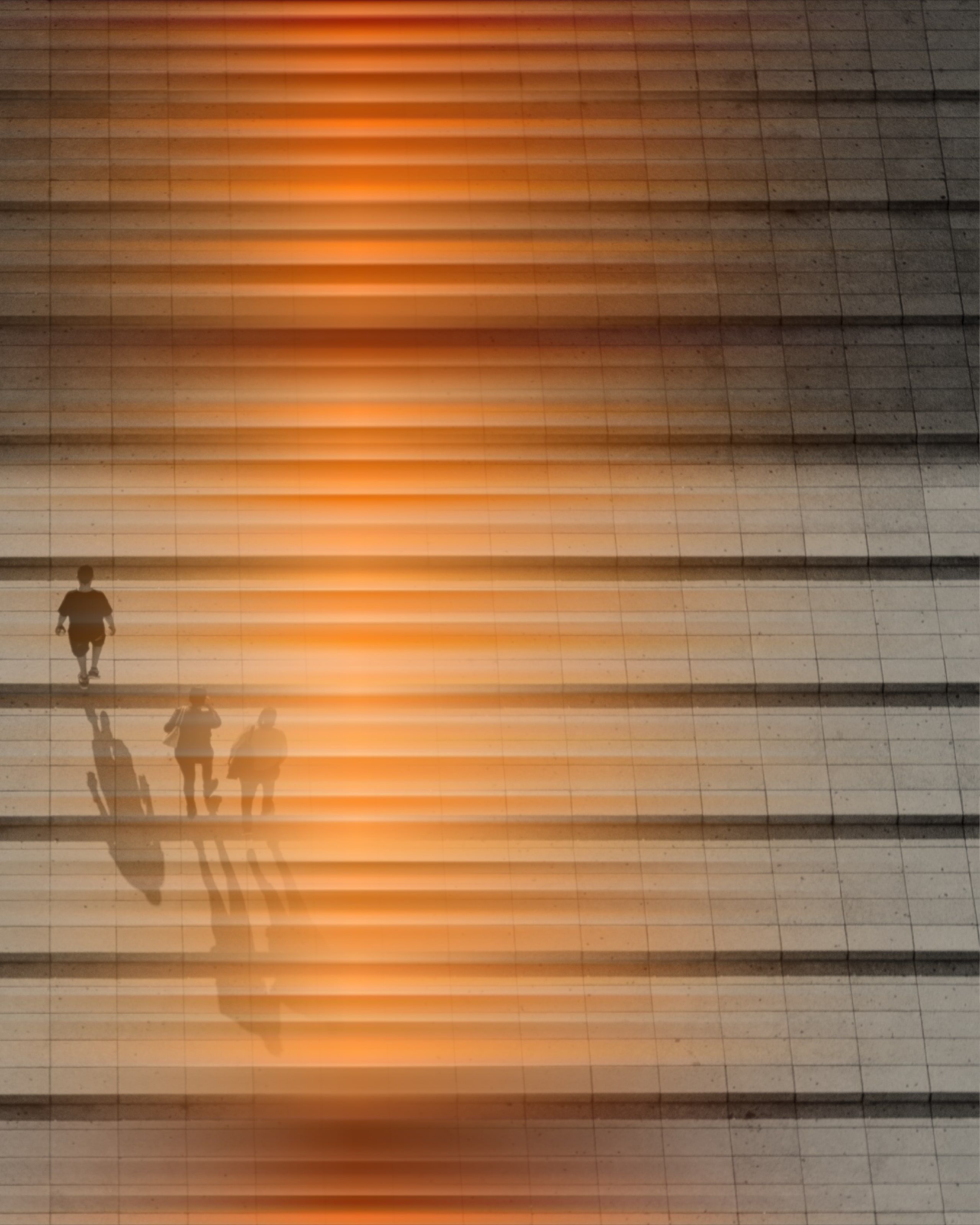 Silhouettes climbing a staircase in orange light